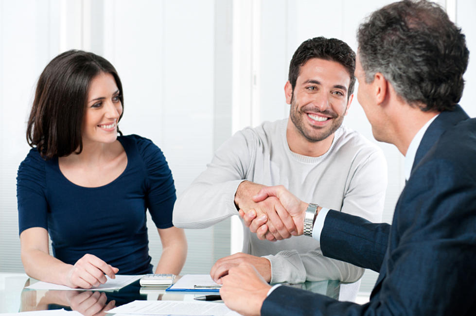 Loan officer shaking hands with clients